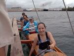 smiling travelers on Captain Kiko's double canoe